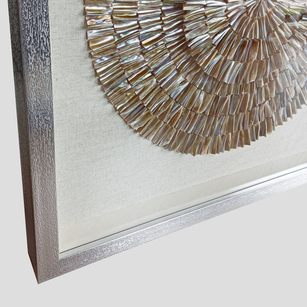 Silver framed shell wall art displayed in luxury hotel lobby interior
