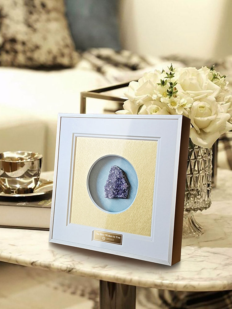 Natural amethyst cluster displayed in decorative shadow box frame, side view