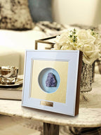 Natural amethyst cluster displayed in decorative shadow box frame, side view